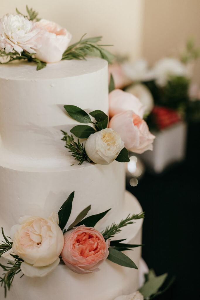 beautiful wedding cake three tiers with garden roses, rosemary, and other floral